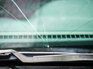 Windscreen cracks while driving, showing a damaged car window up close.