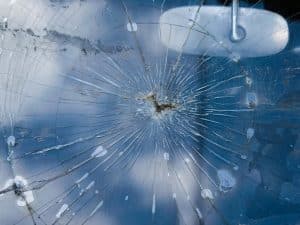 Close-up of a severely cracked car windscreen. Shows the danger when windscreen cracks while driving