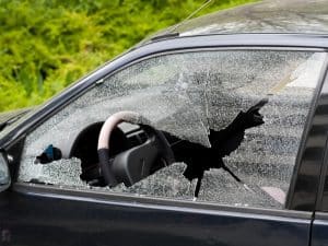 A smashed car side window highlights the risk of "diy side window repair" and potential security issues.
