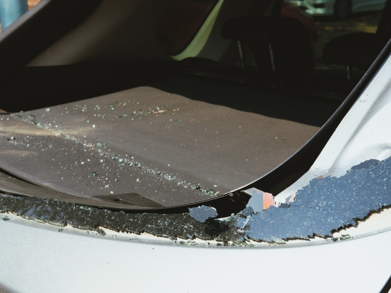 Interior view showing smashed rear windscreen with broken glass on car boot cover