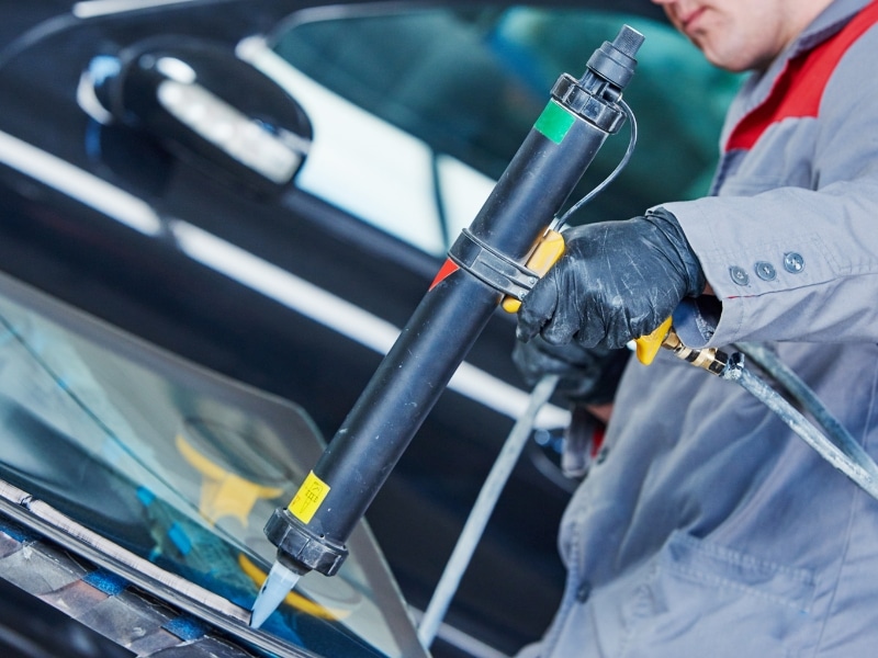 Sealant applied on rear window of the car during replacement process